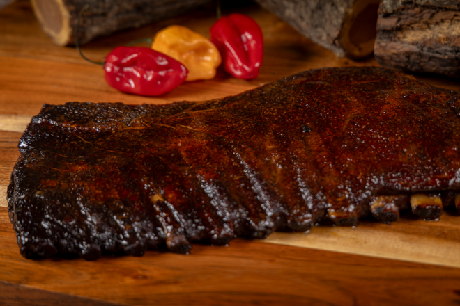 Close-up of flavorful sausages grilling on barbecue, perfect for a summer meal.