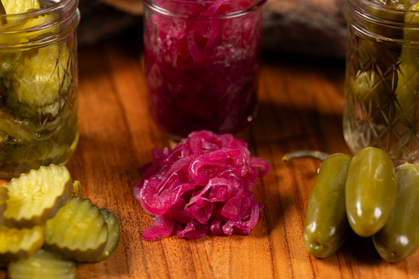 Tasty Texas-style BBQ beef sliders topped with pickles and onions, perfect for parties.
