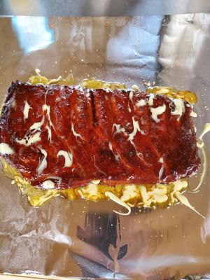 A close-up image of a person holding a delicious bacon sandwich, ready to enjoy.
