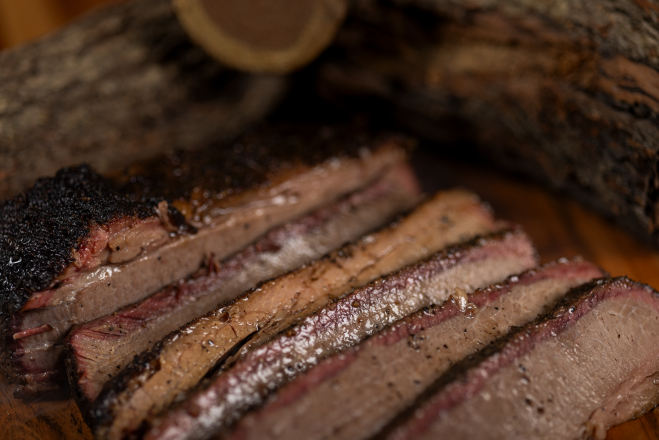 Close-up of sliced grilled beef with rich seasoning at a traditional Brazilian barbecue in Londrina.